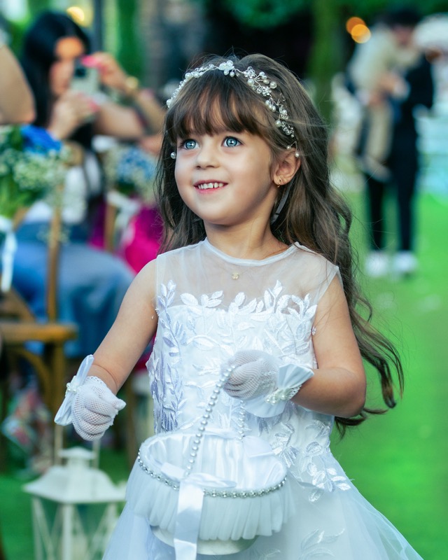 Young girl in a white dress at a celebration